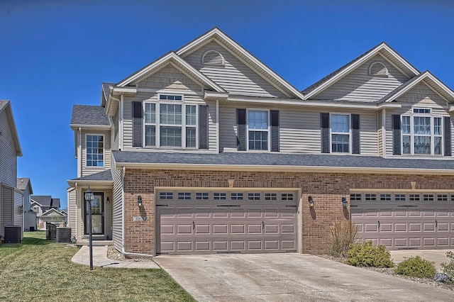 view of front of property with central AC and a garage