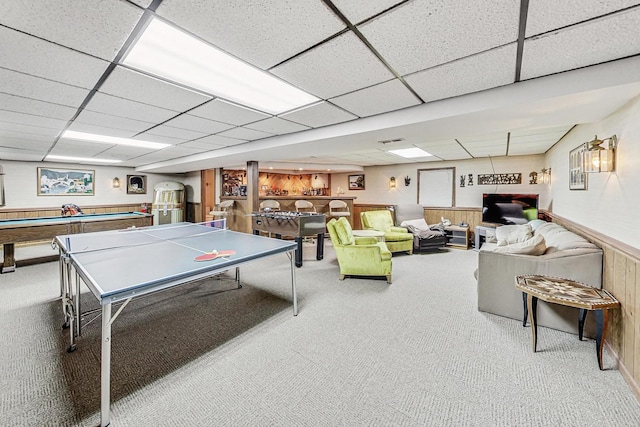 recreation room with a paneled ceiling, carpet, billiards, and wooden walls