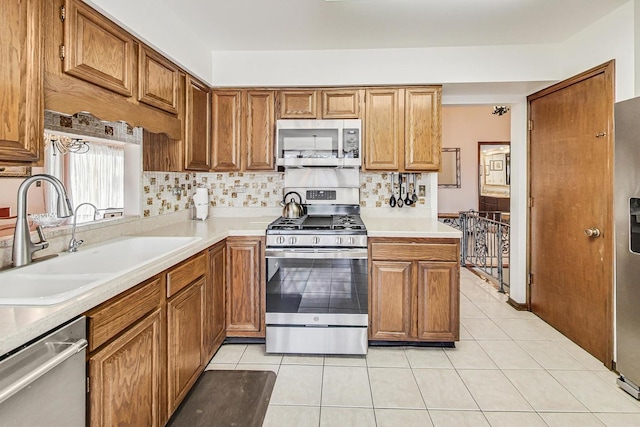 kitchen with sink, light tile patterned floors, and stainless steel appliances