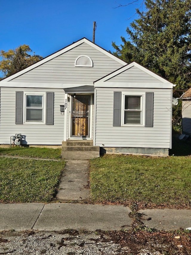 bungalow-style house featuring a front yard