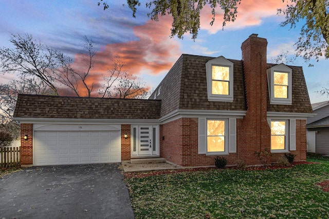 view of front of home with a garage and a yard