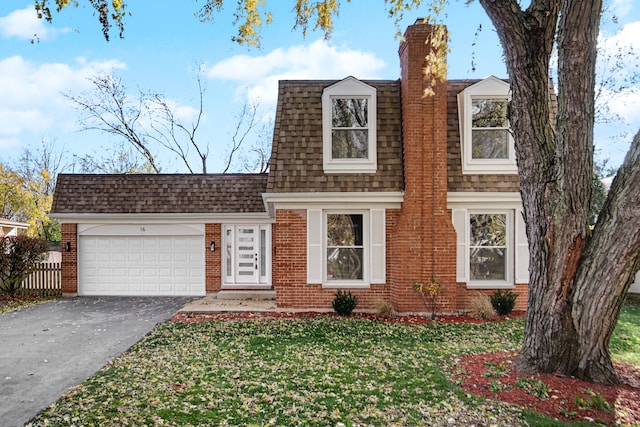 view of front of house featuring a garage and a front lawn