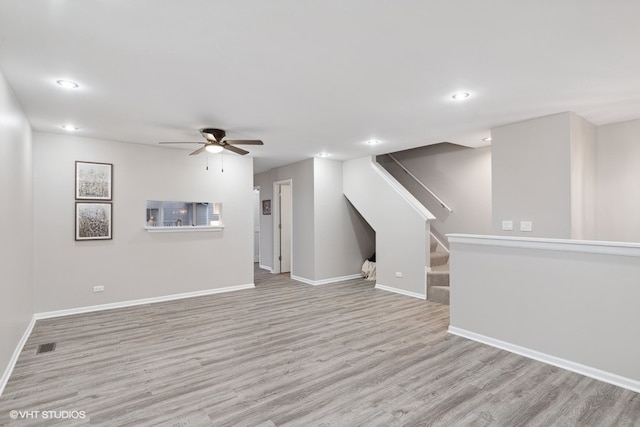 unfurnished living room with light wood-type flooring and ceiling fan