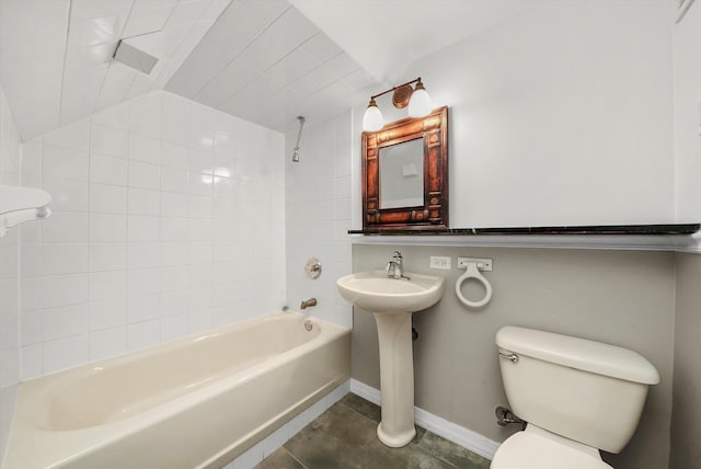 bathroom featuring toilet, tiled shower / bath combo, lofted ceiling, and tile patterned floors