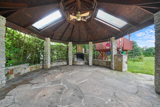 view of patio with an outdoor stone fireplace and a gazebo