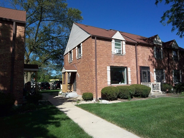 view of side of property featuring a lawn and cooling unit