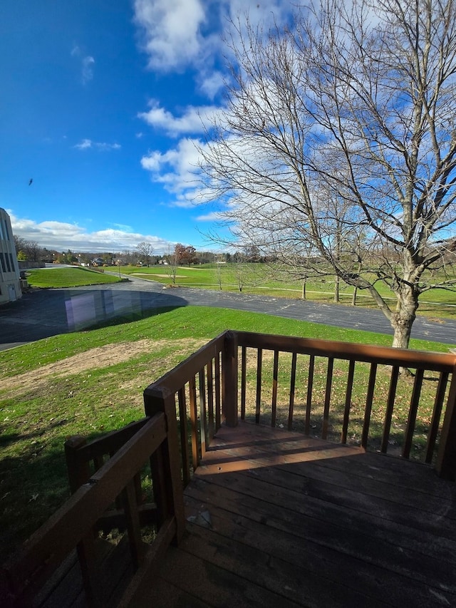 wooden terrace with a lawn