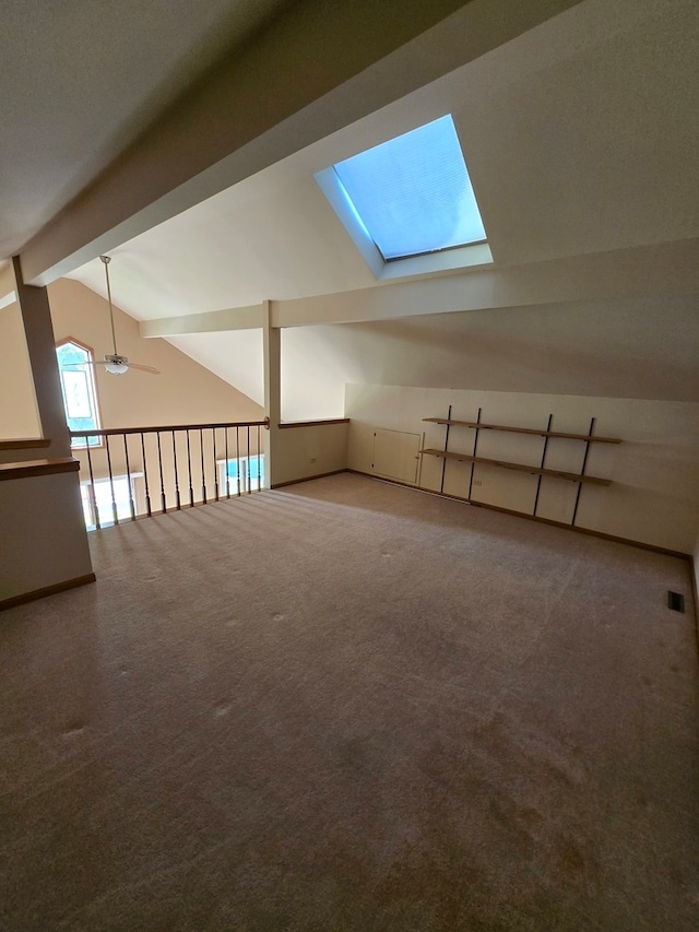 bonus room featuring ceiling fan, carpet flooring, and lofted ceiling with beams