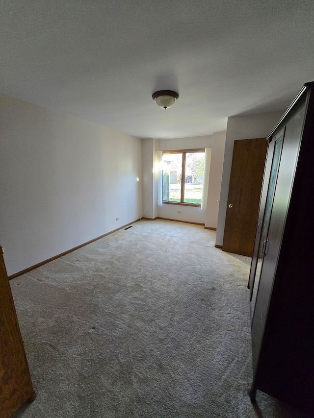 carpeted empty room with a textured ceiling