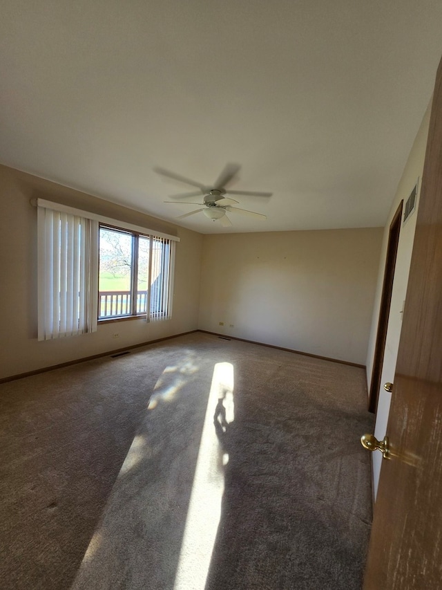 carpeted spare room with ceiling fan