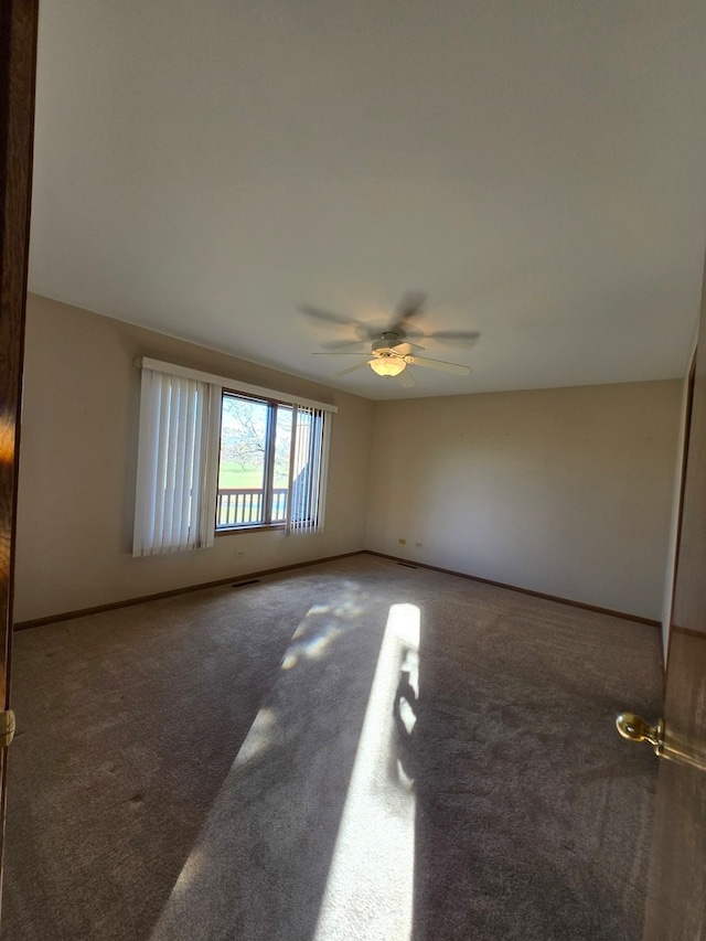 empty room featuring ceiling fan and carpet flooring