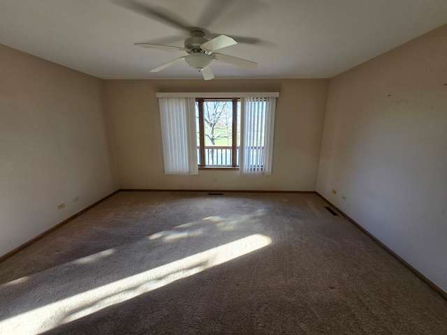 spare room with ceiling fan and carpet floors