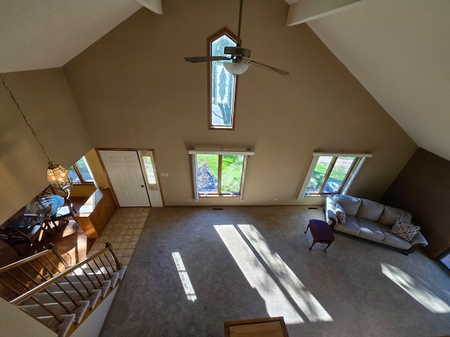 unfurnished living room featuring high vaulted ceiling and a healthy amount of sunlight