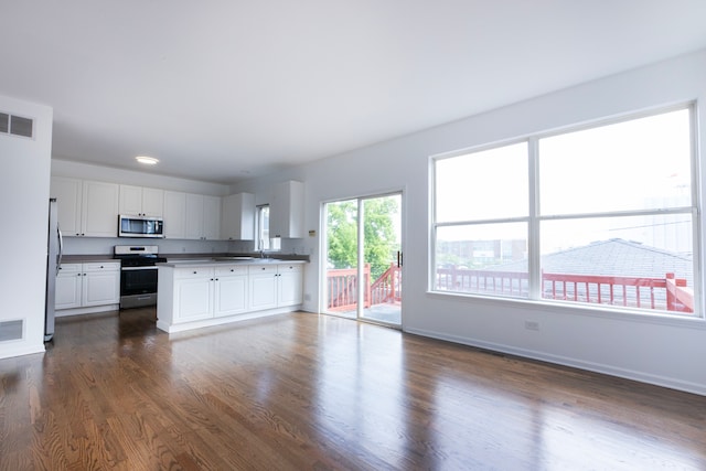 kitchen with white cabinets, stainless steel appliances, dark hardwood / wood-style floors, and sink