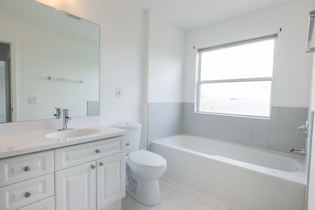 bathroom featuring toilet, vanity, a tub to relax in, and tile patterned floors