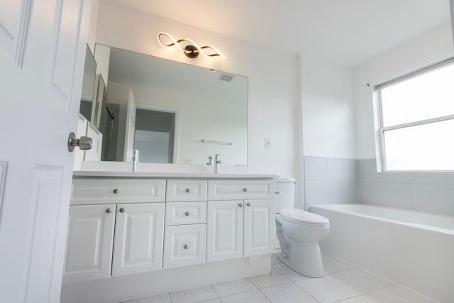 bathroom featuring vanity, tile patterned flooring, a bathing tub, and toilet