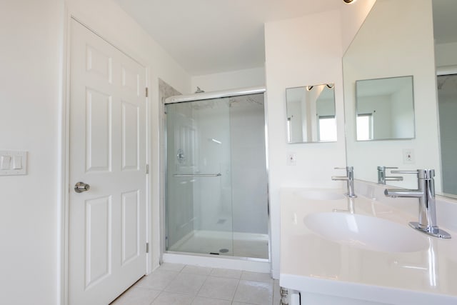 bathroom with walk in shower, tile patterned flooring, and vanity