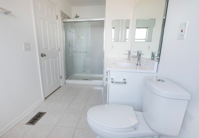 bathroom with tile patterned flooring, an enclosed shower, vanity, and toilet