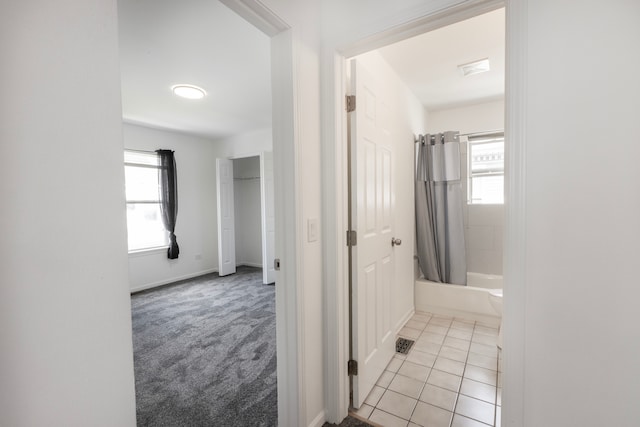 hallway featuring light colored carpet