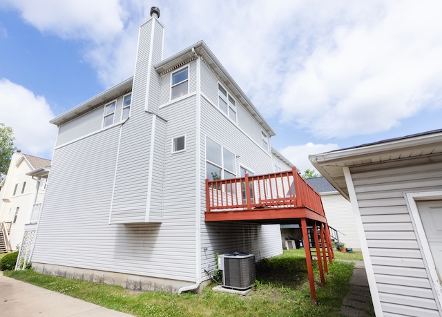 view of side of property featuring central AC and a deck