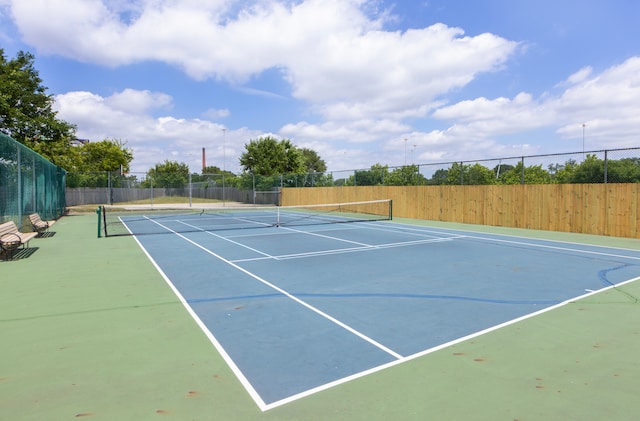 view of tennis court with basketball hoop