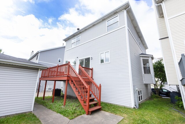 rear view of property featuring a wooden deck