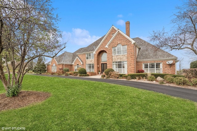 1100 Glencrest Dr, Inverness, IL 60010 - view of front facade with a chimney, a front lawn, and brick siding