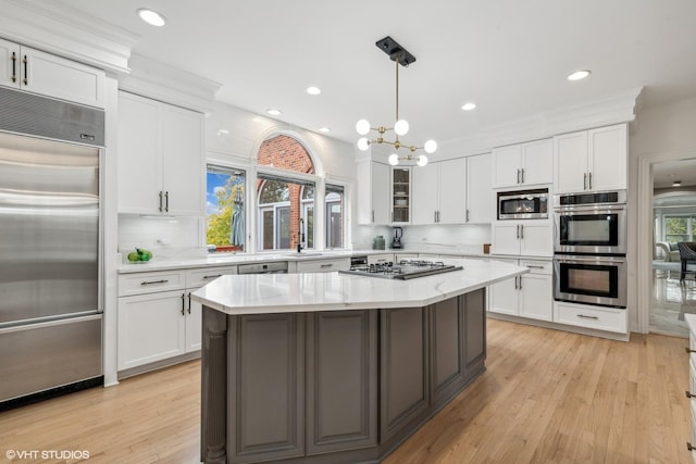 1100 Glencrest Dr, Inverness, IL 60010 - kitchen with built in appliances, white cabinetry, tasteful backsplash, a center island, and recessed lighting
