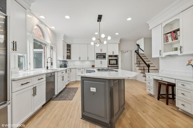 1100 Glencrest Dr, Inverness, IL 60010 - kitchen featuring appliances with stainless steel finishes, a sink, white cabinetry, tasteful backsplash, and light wood-style floors