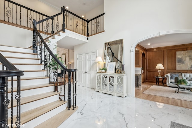 foyer with a high ceiling and wood-type flooring