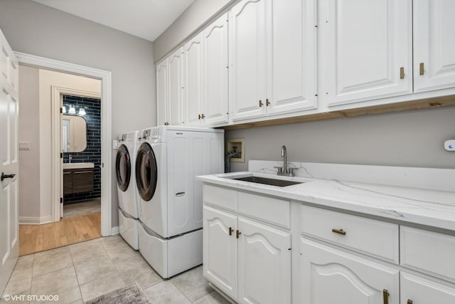 1100 Glencrest Dr, Inverness, IL 60010 - laundry room with cabinet space, washing machine and dryer, light tile patterned floors, and baseboards
