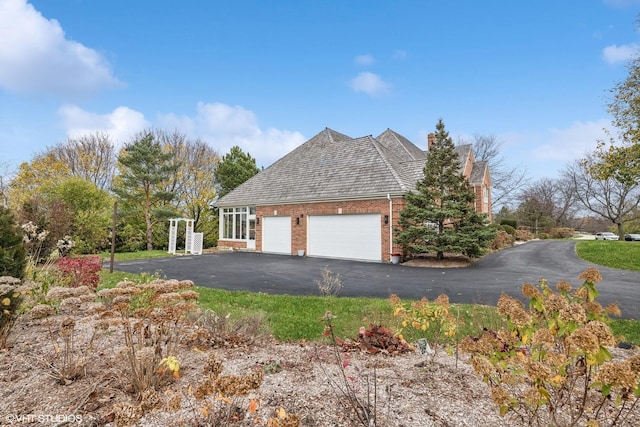 1100 Glencrest Dr, Inverness, IL 60010 - view of side of home with an attached garage, driveway, and brick siding