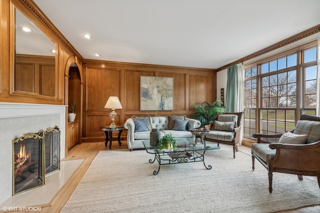 1100 Glencrest Dr, Inverness, IL 60010 - living area with light wood-type flooring, ornamental molding, a fireplace with flush hearth, wood walls, and recessed lighting