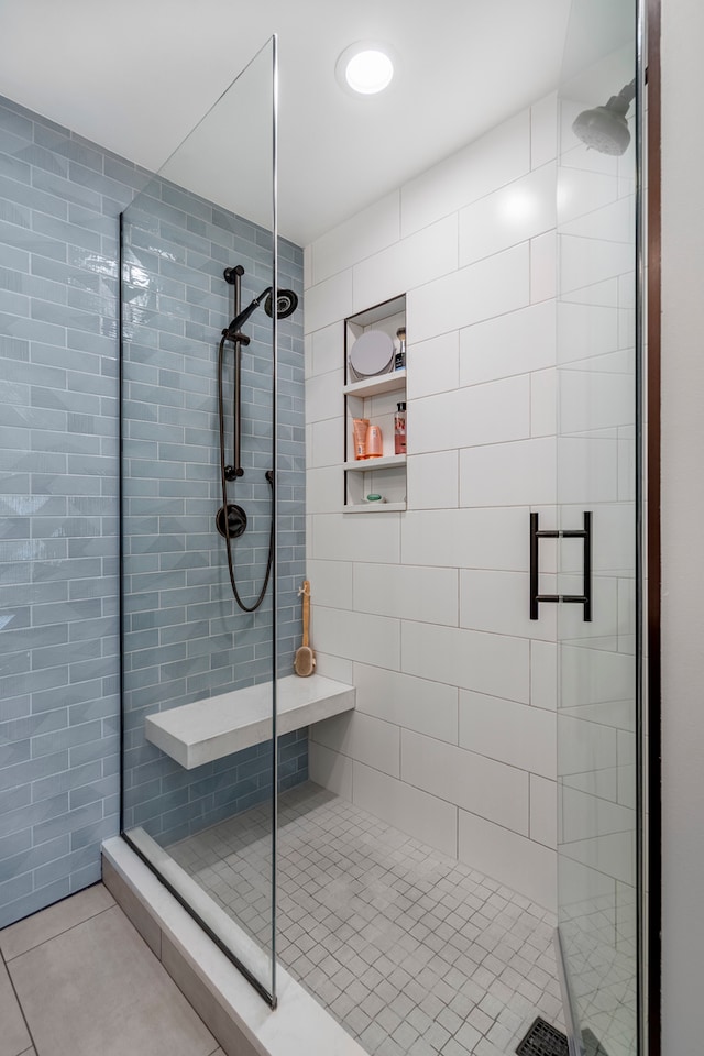 bathroom featuring tile patterned floors and a shower with shower door