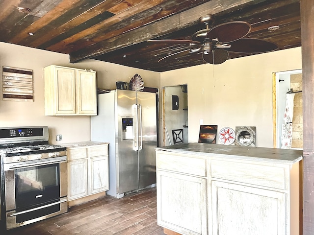 kitchen featuring beam ceiling, dark hardwood / wood-style flooring, stainless steel appliances, and ceiling fan