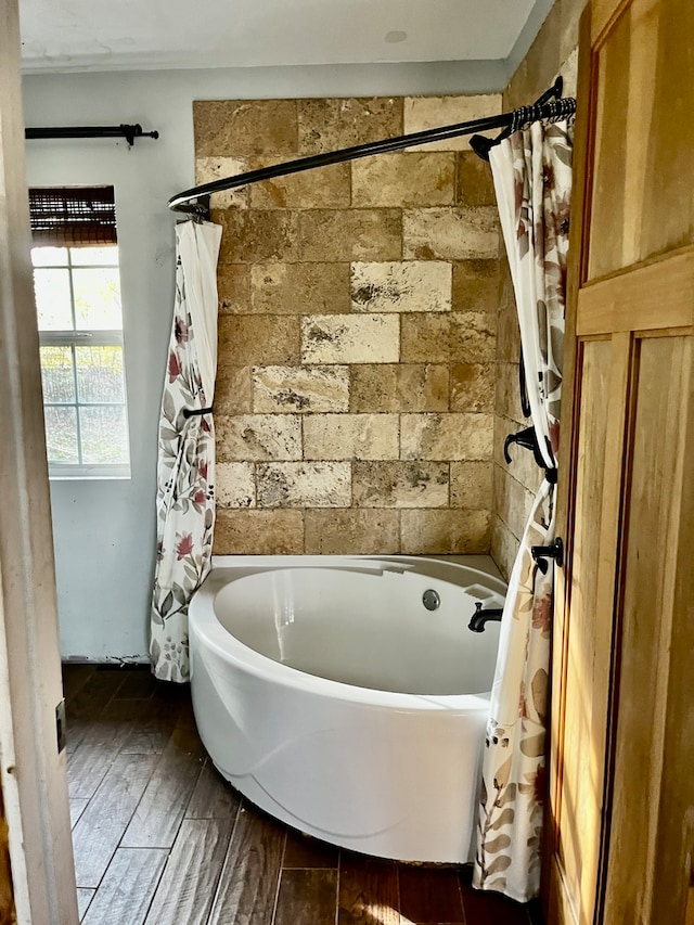 bathroom with wood-type flooring and shower / tub combo