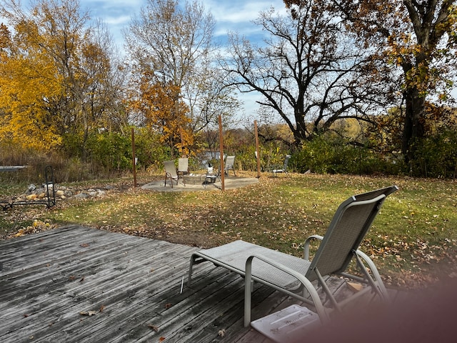 wooden deck featuring a yard and an outdoor fire pit