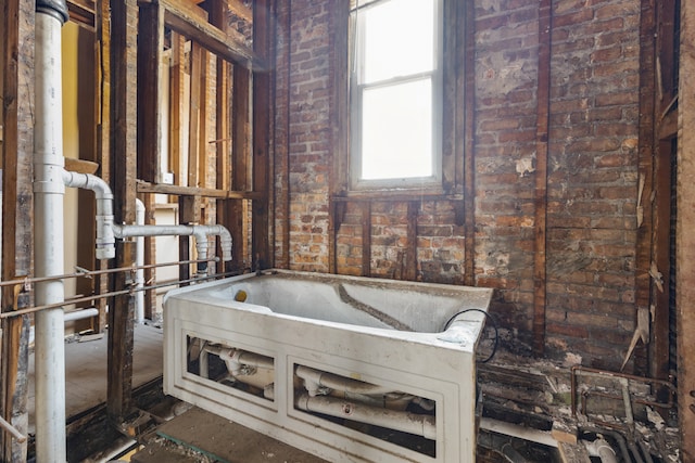 bathroom featuring brick wall