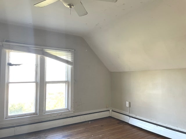 additional living space featuring ceiling fan, dark hardwood / wood-style flooring, a healthy amount of sunlight, and lofted ceiling