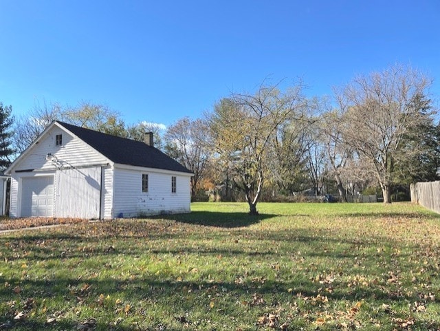 view of yard with a garage and an outdoor structure