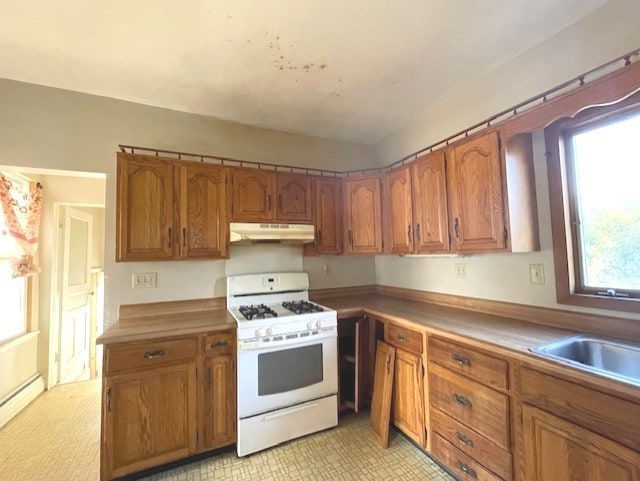 kitchen with baseboard heating, white range with gas cooktop, and light carpet