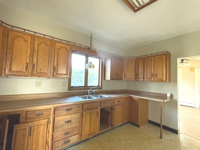 kitchen with baseboard heating and sink