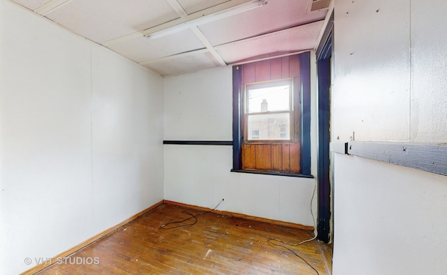 unfurnished room with wood-type flooring