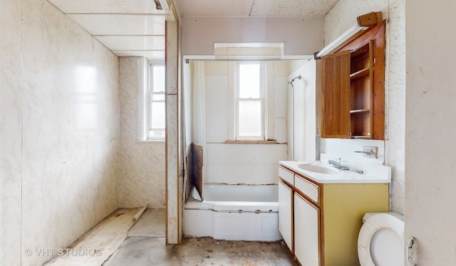 full bathroom featuring toilet, concrete flooring, vanity, and shower / bathtub combination