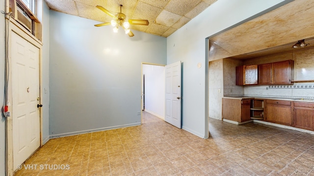 kitchen with high vaulted ceiling, tasteful backsplash, and ceiling fan