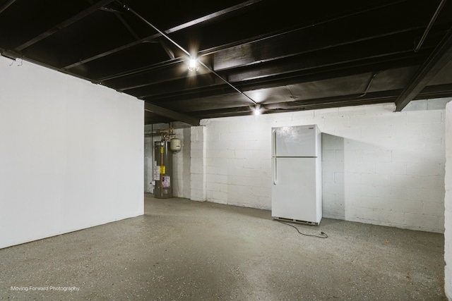 basement with white fridge and gas water heater