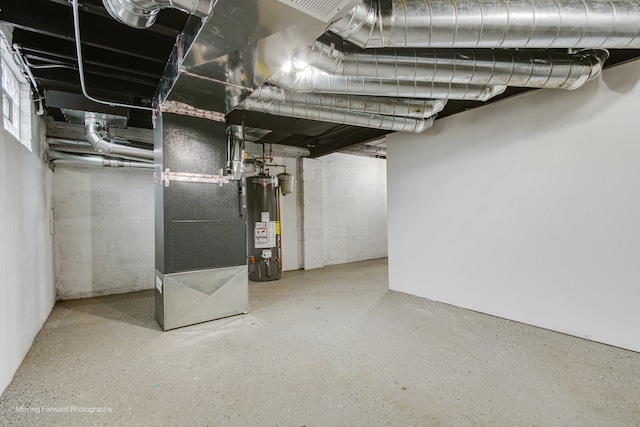 basement featuring heating unit and water heater