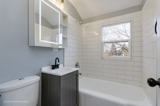 full bathroom with vanity, toilet, tiled shower / bath, and lofted ceiling