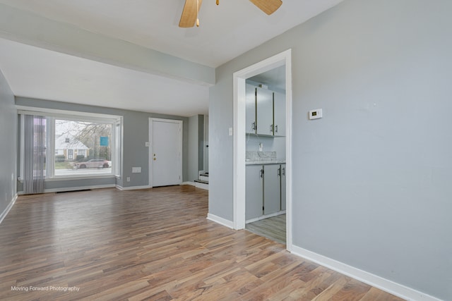 unfurnished living room with ceiling fan and light hardwood / wood-style floors