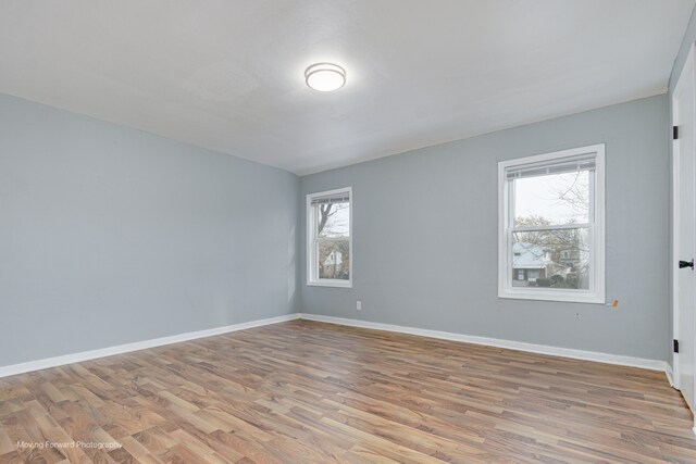 unfurnished room with a wealth of natural light and light hardwood / wood-style flooring